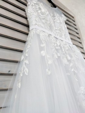 lace appliqued white tulle wedding gown