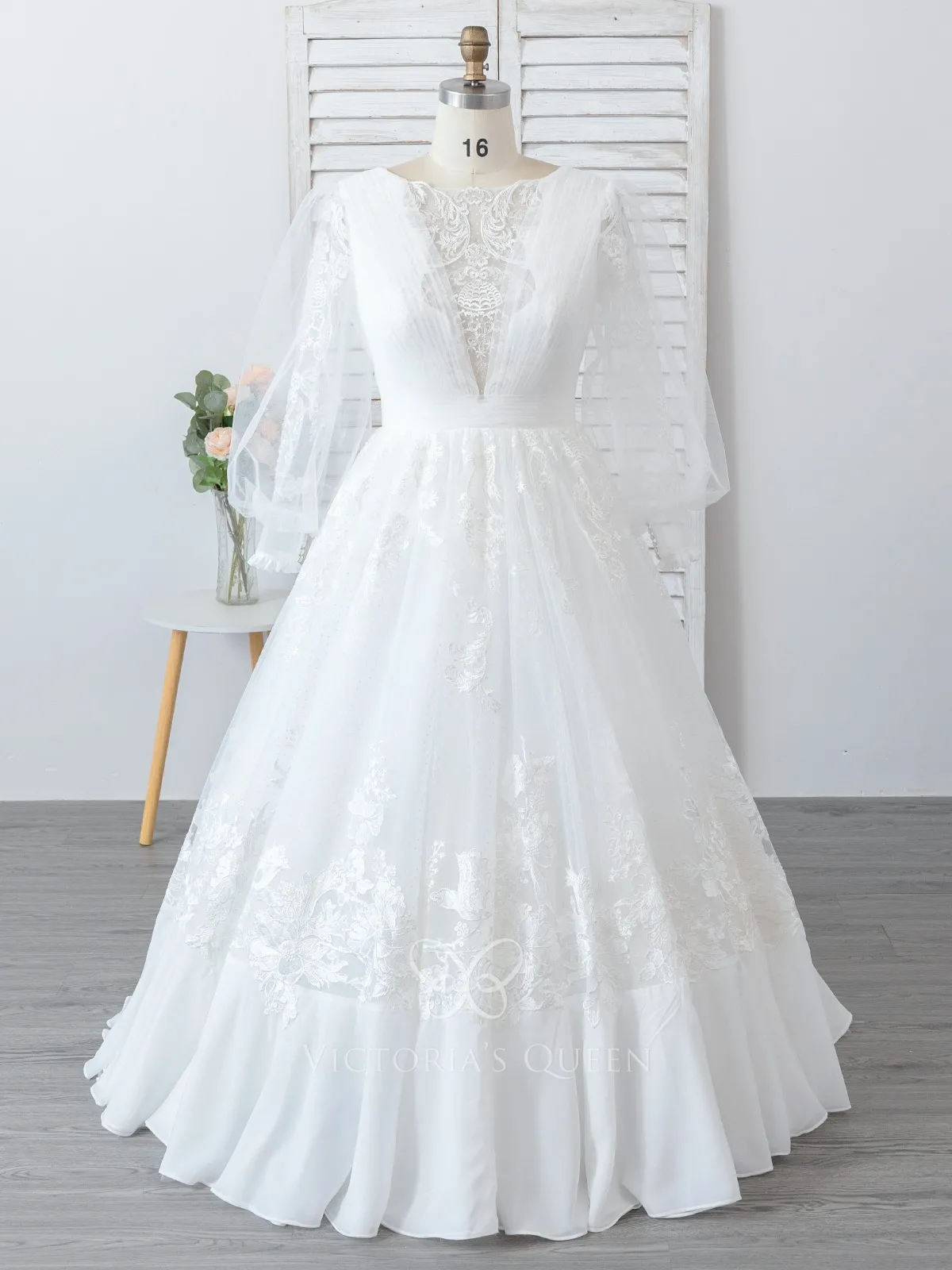 sheer long sleeve wedding gown with ruffled hemline skirt