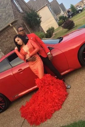 Red glitter and ostrich feather long sleeve mermaid African American prom gown