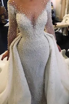 heavily pearled long winter wedding gown with overskirt
