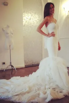 cascading ruffled long train body hugging wedding gown