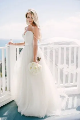 Ivory tulle plunging sweetheart wedding ball gown with spaghetti straps