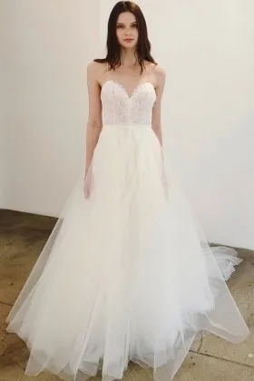 romantic white lace and tulle wedding dress with feminine spaghetti straps