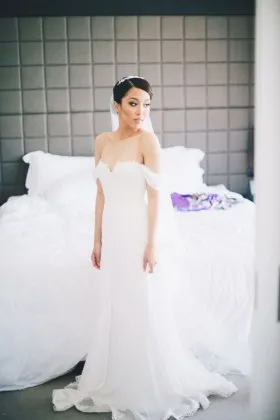 Feminine off the shoulder white lace and tulle floor length A line wedding dress