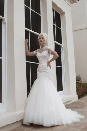 Feminine and fairy tale ivory tulle fishtail wedding dress with intricate lace detail